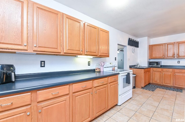 kitchen with electric range and light tile patterned floors