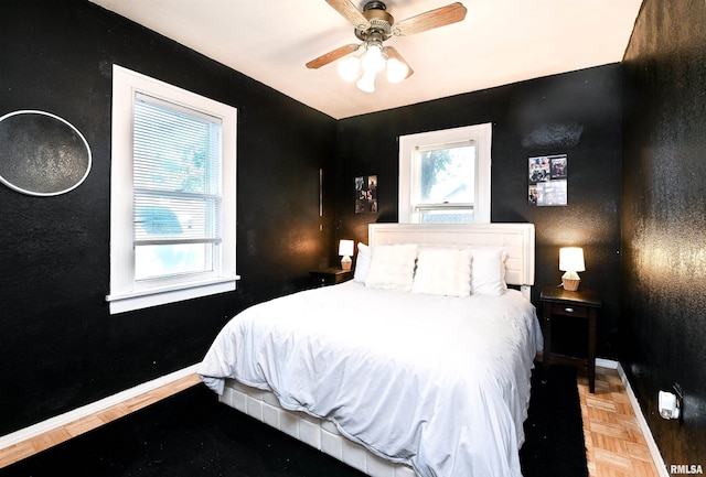 bedroom featuring parquet flooring and ceiling fan