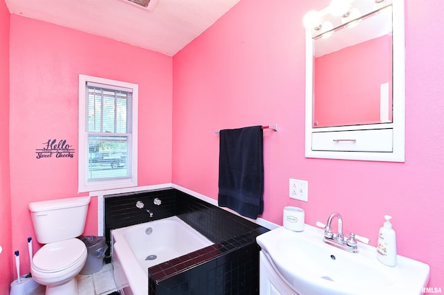 bathroom with vanity, toilet, a bath, and tile patterned flooring