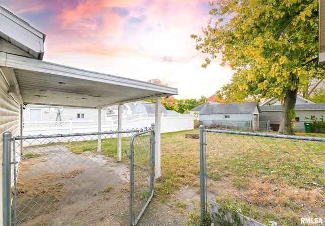 yard at dusk featuring a storage shed