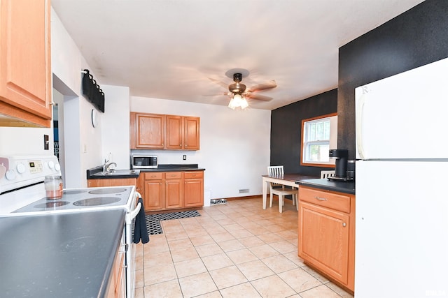 kitchen featuring ceiling fan, sink, light tile patterned floors, and white appliances