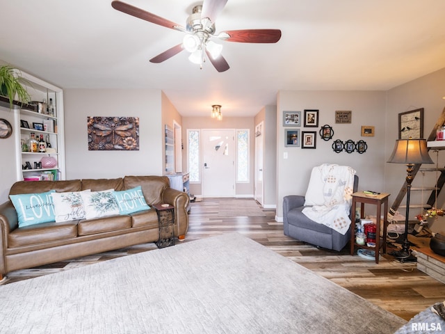 living room with hardwood / wood-style flooring and ceiling fan