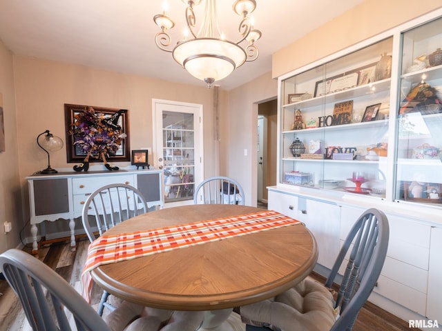 dining area with a chandelier and dark hardwood / wood-style flooring