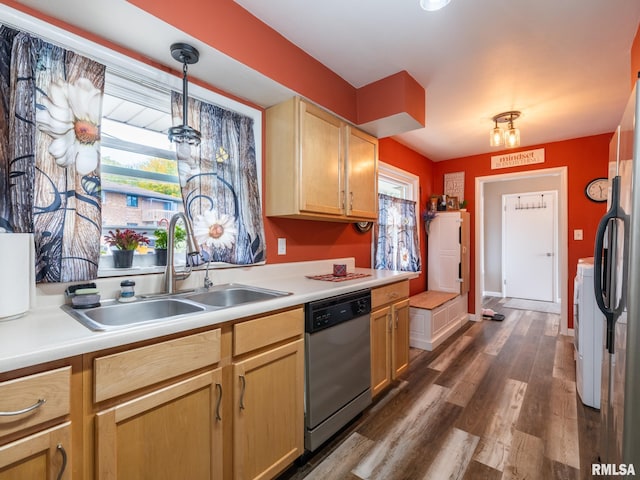 kitchen featuring dark hardwood / wood-style floors, hanging light fixtures, light brown cabinetry, sink, and stainless steel dishwasher