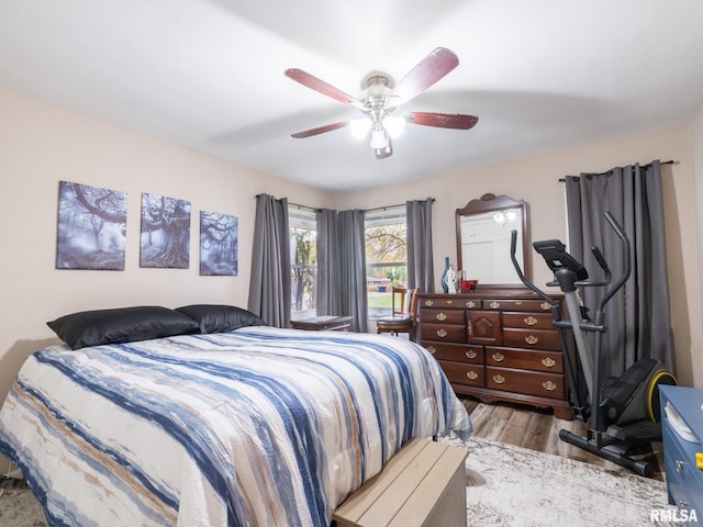 bedroom featuring light wood-type flooring and ceiling fan