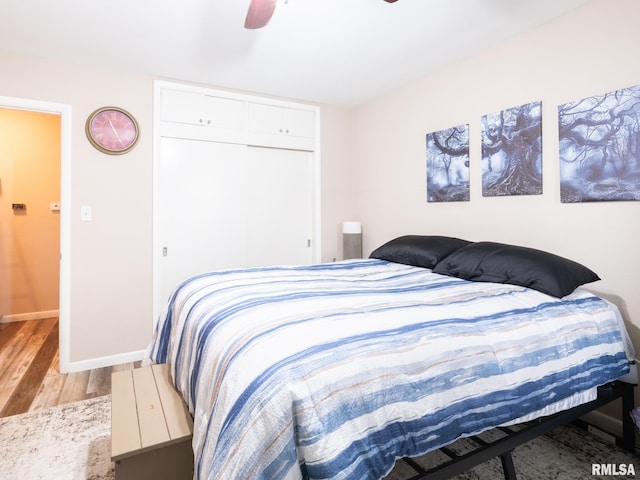 bedroom featuring a closet, ceiling fan, and light wood-type flooring