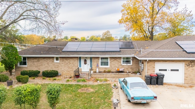 view of front of home with solar panels and a garage