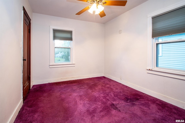 carpeted spare room featuring ceiling fan