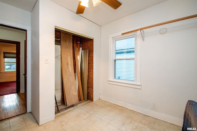 empty room with light hardwood / wood-style floors and ceiling fan