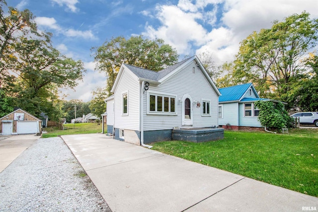 view of front of house with a front yard, an outdoor structure, and a garage