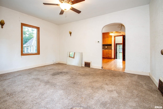 unfurnished room featuring light colored carpet and ceiling fan