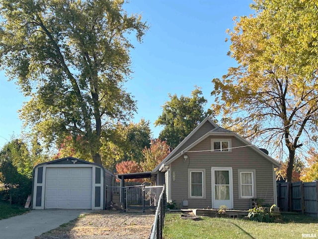 view of front facade featuring an outdoor structure, a garage, and a front lawn