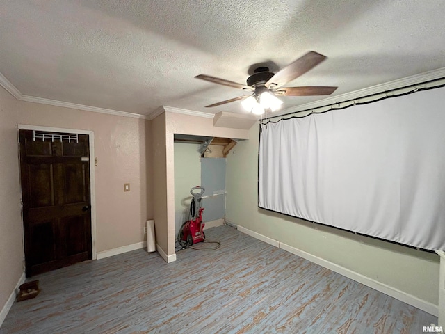 interior space with a closet, crown molding, a textured ceiling, light hardwood / wood-style floors, and ceiling fan