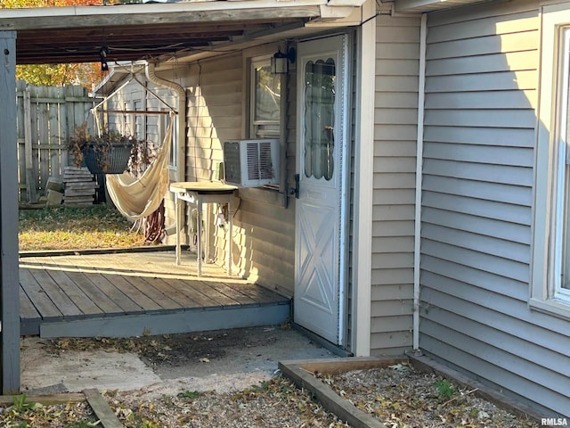 entrance to property with cooling unit and a deck