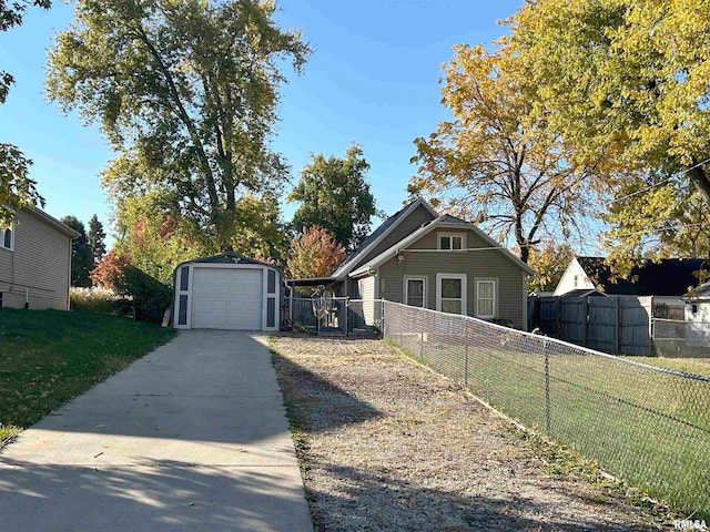 view of front facade with a garage, a front lawn, and an outbuilding