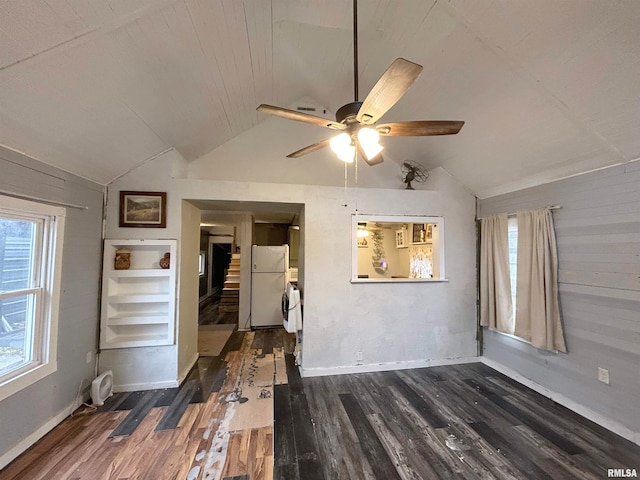 empty room with ceiling fan, lofted ceiling, and dark hardwood / wood-style flooring