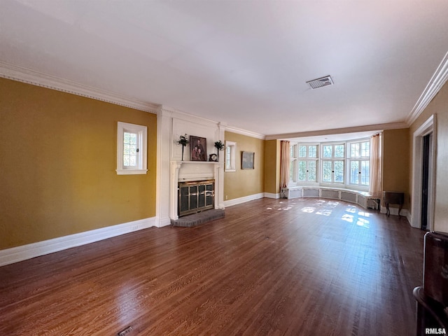 unfurnished living room featuring crown molding, dark hardwood / wood-style flooring, and plenty of natural light