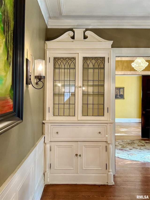 interior details with hardwood / wood-style floors and crown molding