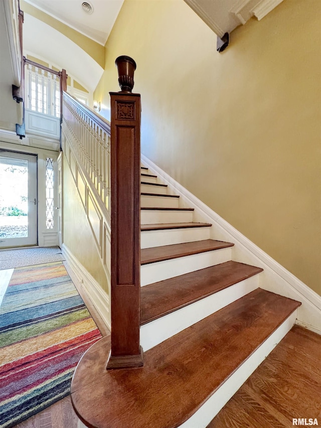 stairs with hardwood / wood-style flooring