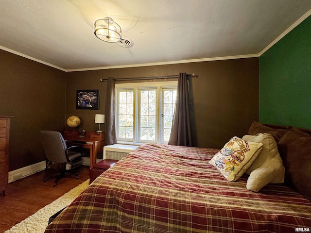 bedroom featuring crown molding and hardwood / wood-style flooring