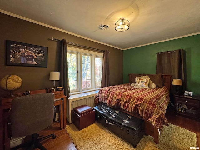 bedroom featuring ornamental molding and wood-type flooring