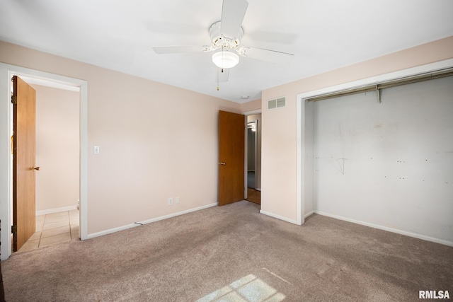 unfurnished bedroom featuring light colored carpet, a closet, and ceiling fan