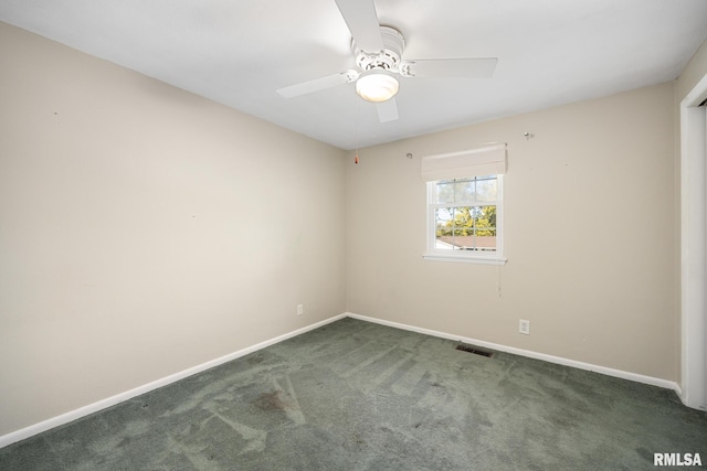 unfurnished room with dark carpet and ceiling fan