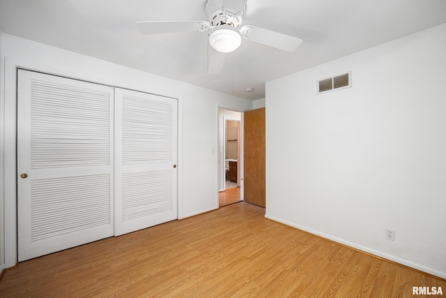 unfurnished bedroom featuring a closet, ceiling fan, and light wood-type flooring