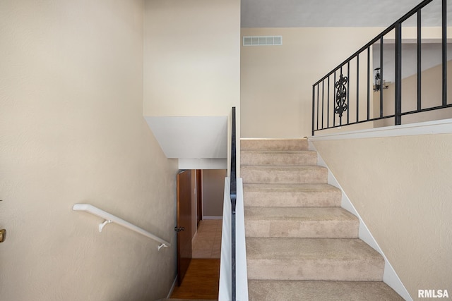 stairs featuring hardwood / wood-style flooring