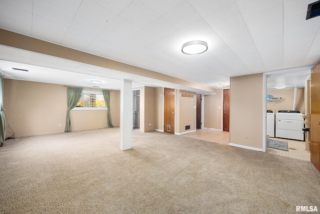 basement featuring washer and dryer and light carpet