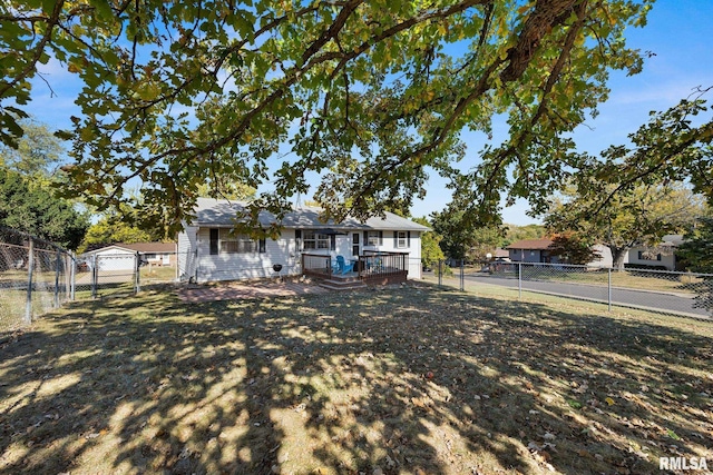 view of front of house with a front yard and a wooden deck