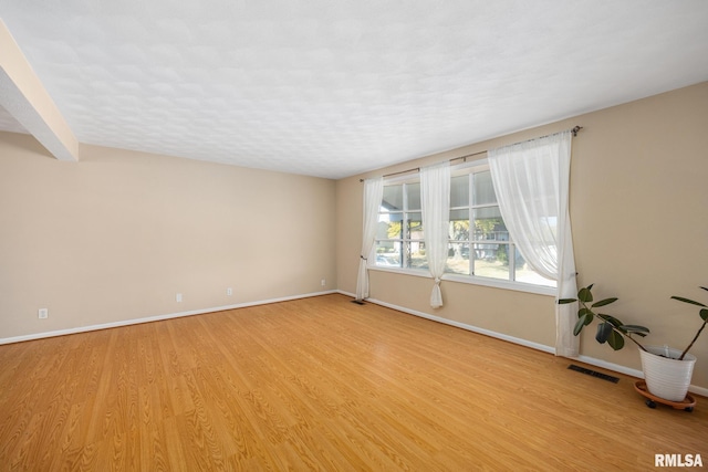 spare room with light hardwood / wood-style floors