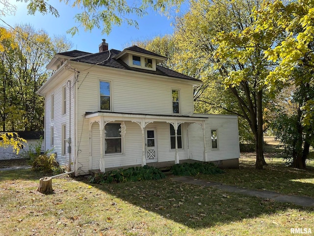 view of front of home with a porch and a front lawn