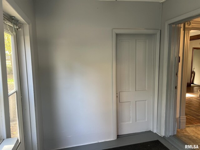 interior space with ornamental molding and dark wood-type flooring