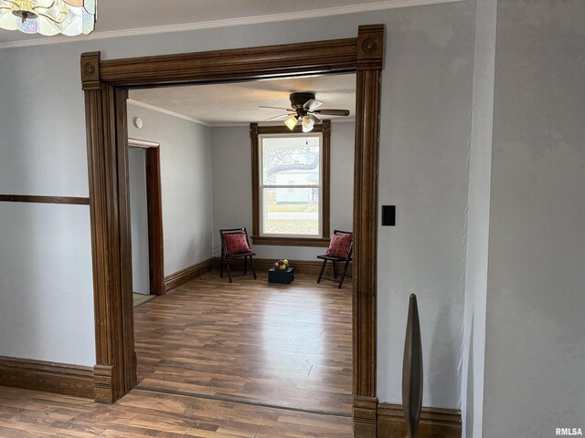 unfurnished room with ornamental molding, dark wood-type flooring, and ceiling fan