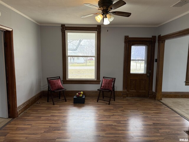 spare room with ornamental molding and dark hardwood / wood-style floors