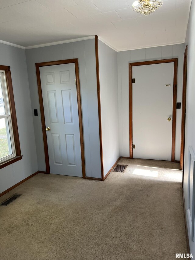 spare room with light hardwood / wood-style floors and ornamental molding