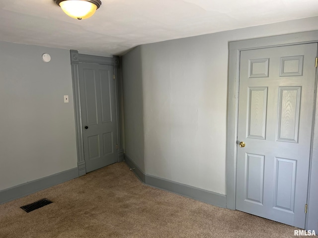 unfurnished room featuring carpet