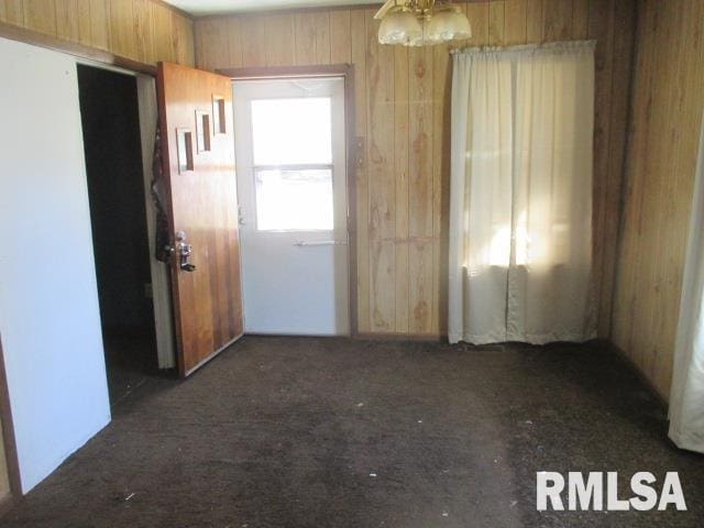 empty room featuring wood walls