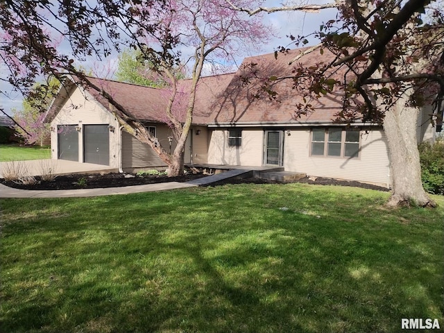 view of front of property featuring a garage and a front lawn