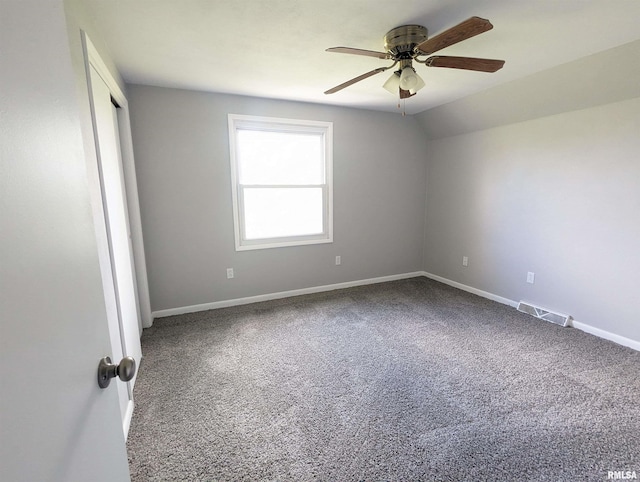 unfurnished room with carpet floors, visible vents, ceiling fan, and baseboards