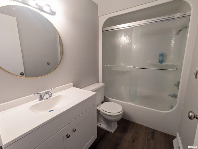 bathroom with toilet, combined bath / shower with glass door, wood finished floors, and vanity