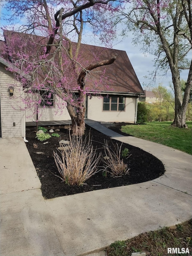 view of side of property with a lawn