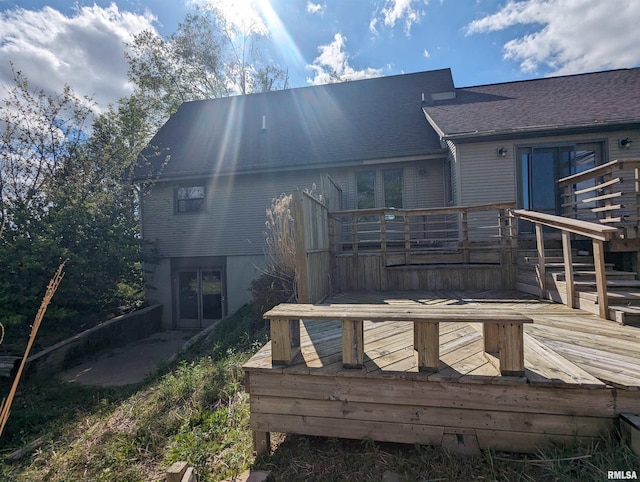 back of property featuring a wooden deck