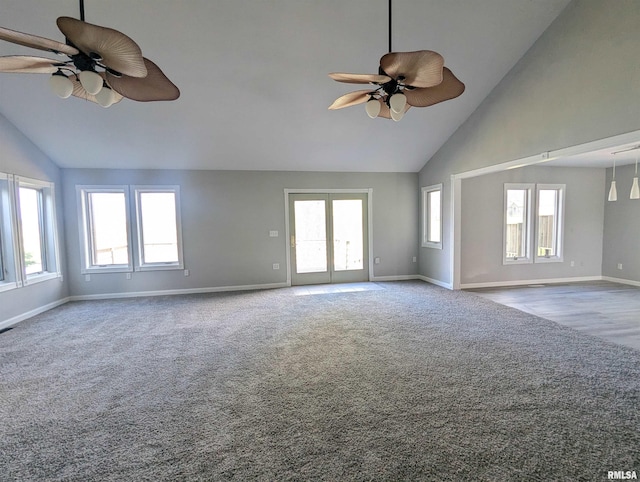 unfurnished room with a wealth of natural light, ceiling fan, and carpet flooring