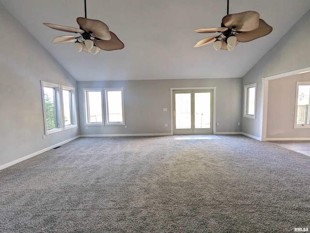 carpeted empty room with high vaulted ceiling, ceiling fan, and baseboards