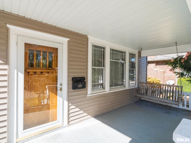 view of exterior entry with covered porch