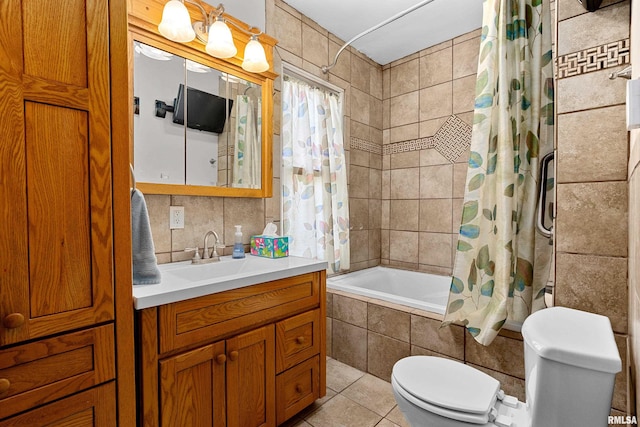 full bathroom with tile walls, toilet, shower / bath combo, vanity, and tile patterned floors