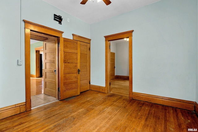 unfurnished bedroom with ceiling fan and light hardwood / wood-style flooring