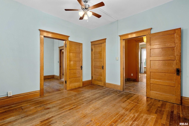 unfurnished bedroom with wood-type flooring and ceiling fan